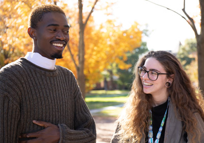 Two students talk to one another on campus|Two students talk to one another on campus