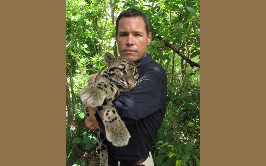 A photo of Jeff Corwin holding a cloud leopoard