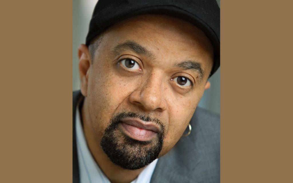 James McBride headshot with brown background