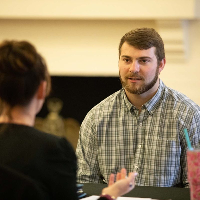Man speaking to women during mock interview
