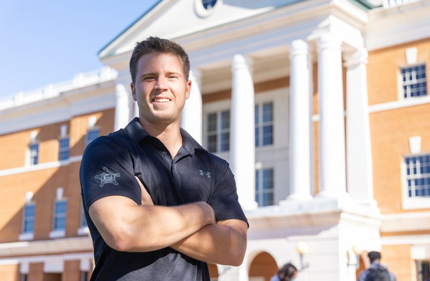 Alex Schwind in front of McKinney building