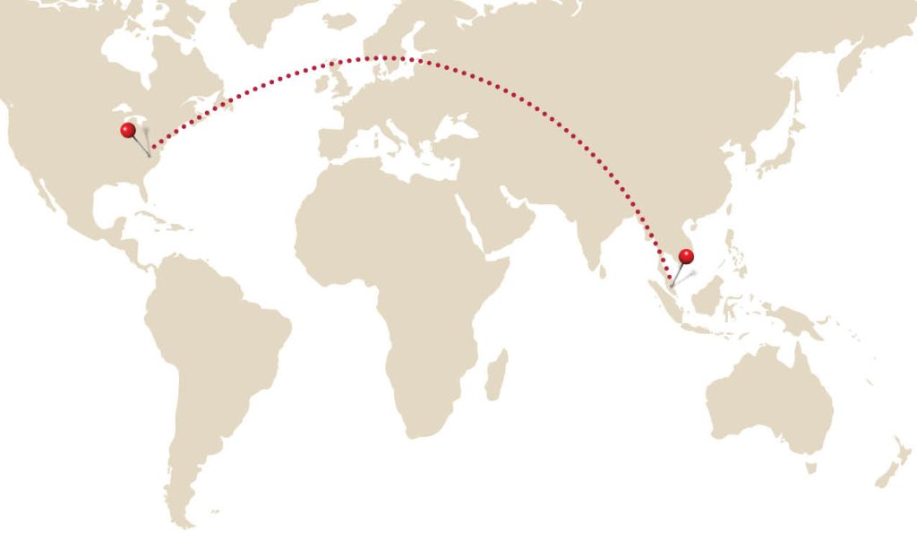 Map of the world with pin in the United States connected to pin in Malaysia