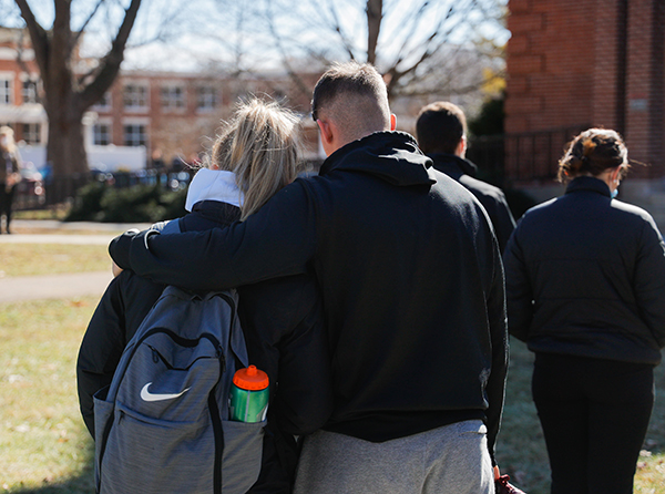 Two students hug each other on Bridgewater College's campus