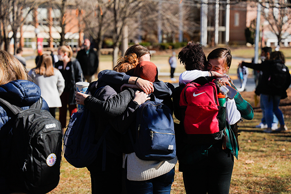Students embrace each other on Bridgewater College's campus