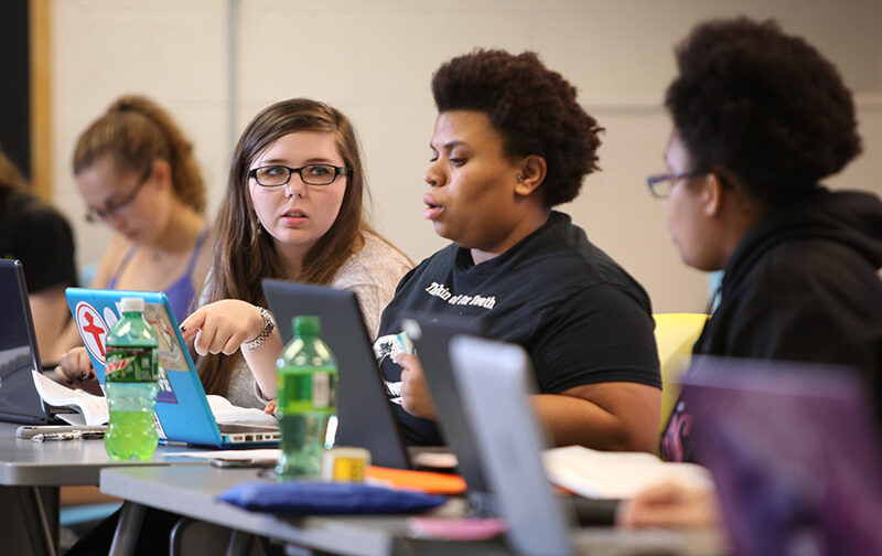 Student working on laptops in psychology class