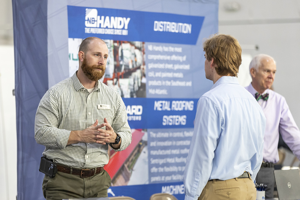 Employer speaking with student at career and internship fair