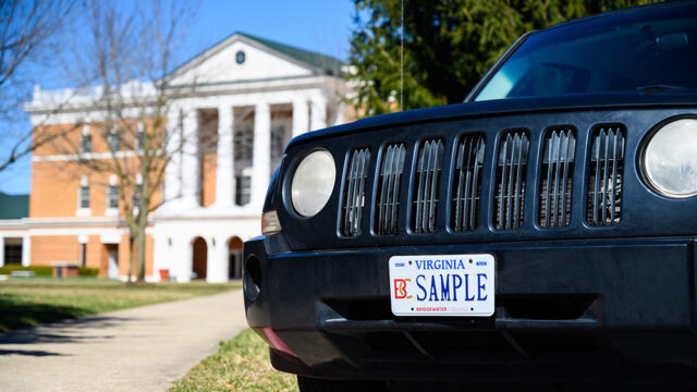 B-C Sample License plate on a black jeep parked in front of McKinney