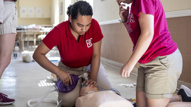 Students learning C-P-R on a dummy