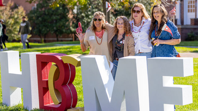 Group of four ladies posing for a photo in the front of the B-C home letters