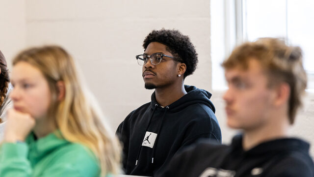 Student sitting looking attentive in class