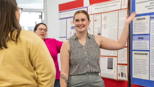 Student pointing to project board