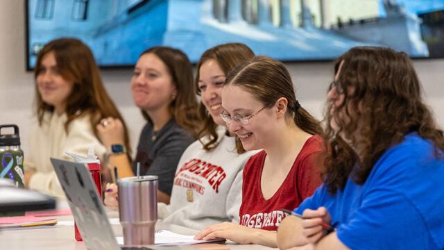 Row of women sitting in class smiling