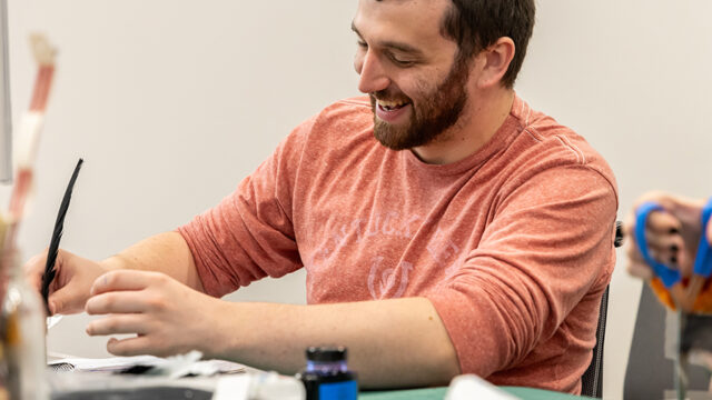 Student working with a quill pen