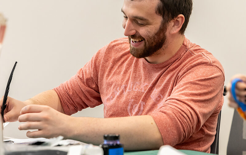 Student working with a quill pen