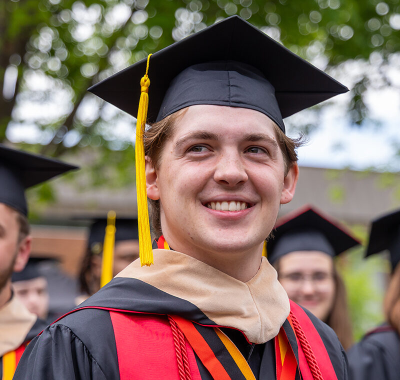 Bridgewater College graduate wearing cap and gown