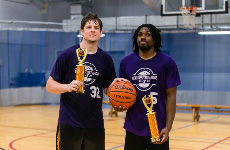 Mason Ramey and Keiman Dillon pose with their trophies and a basketball.