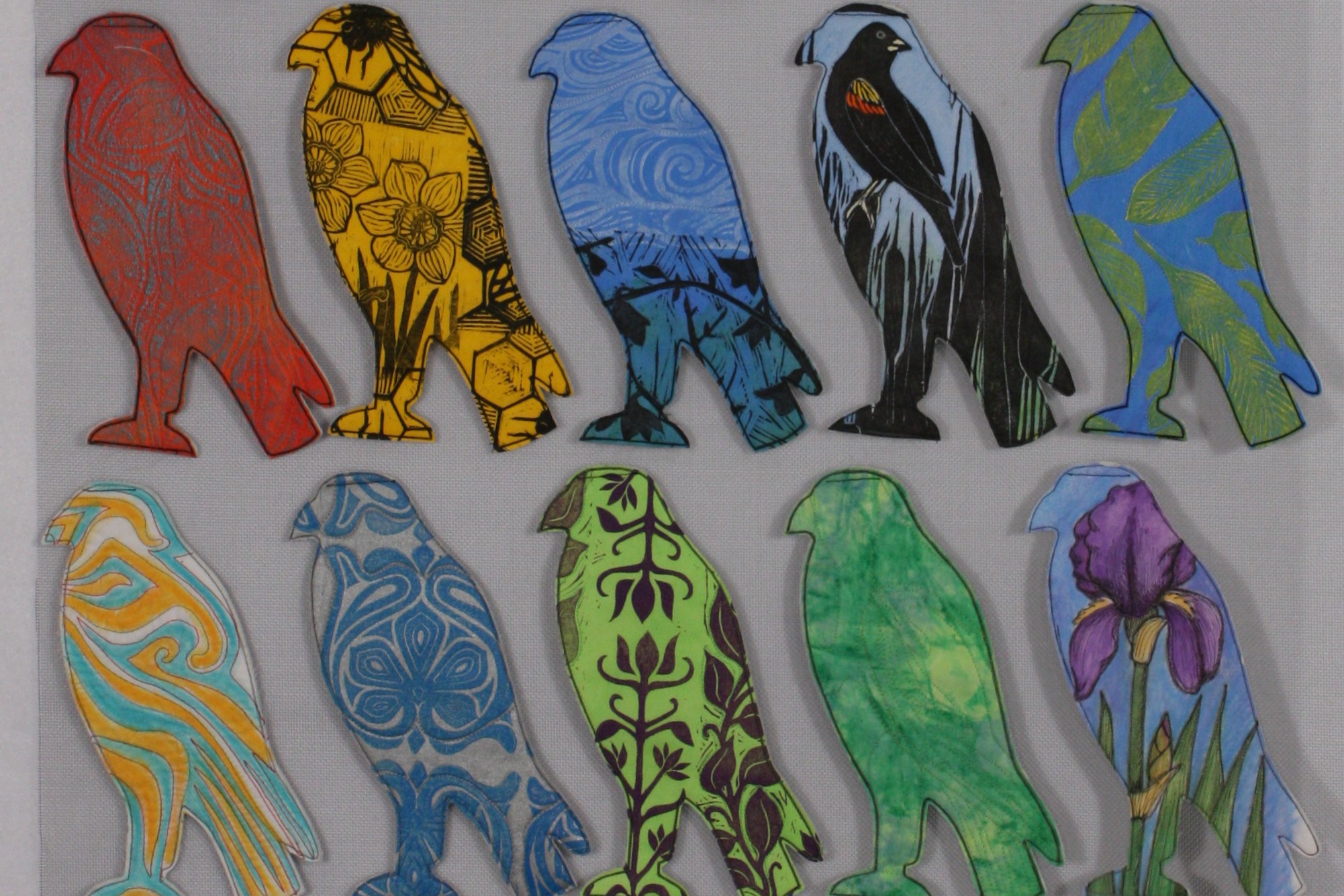 Ten bird silhouettes with colorful patterns