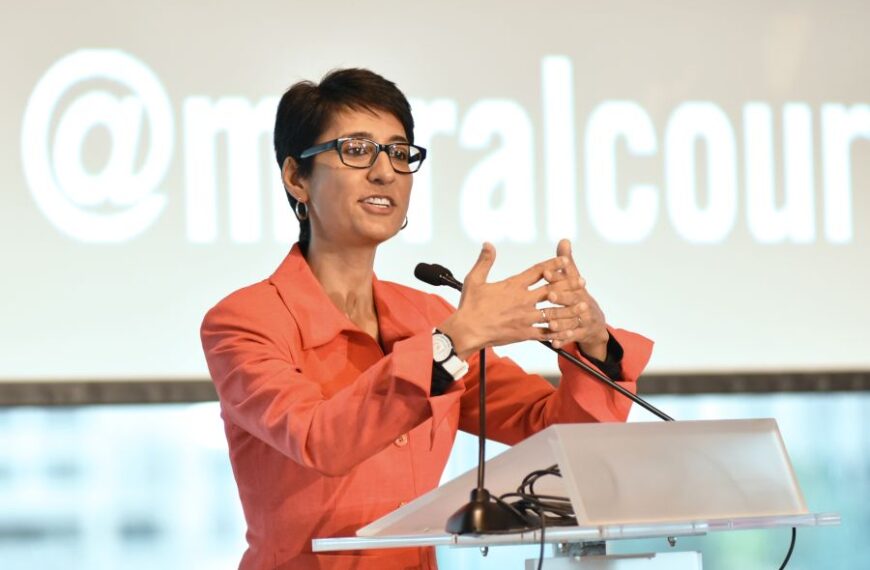 Irshad Manji speaking at a podium