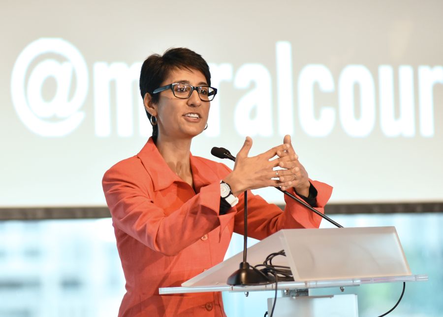 Irshad Manji speaking at a podium