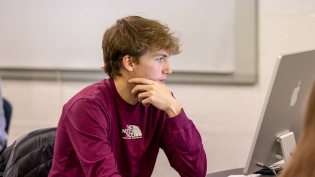 A student focuses on his computer